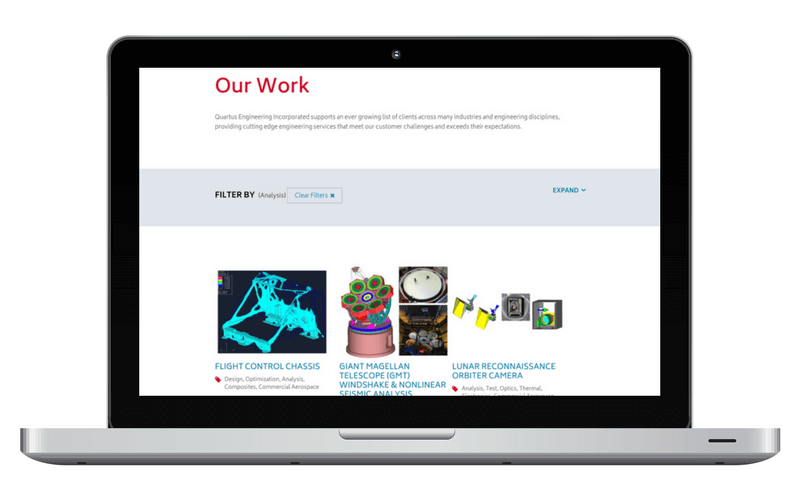 Laptop mockup of the Our Work section of the Quartus site.